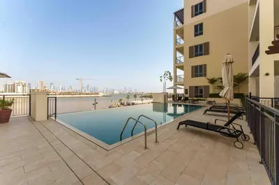 a swimming pool on the balcony of a building at Beach stylish full sea view in Dubai