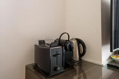 a printer sitting on a table next to a wall at Elevated Living studio in Sparkle Tower- Suiteable in Dubai