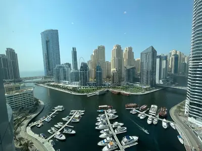 a group of boats docked in a harbor in a city at Dubai Marina Walk Gem Modern Apartments with Pool & Gym access, Steps to Beach & Metro Managed by SunnyHomes in Dubai