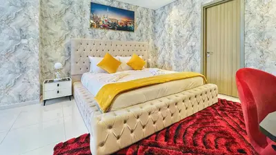 a bedroom with a large bed with a red carpet at Best Burj Khalifa View Balcony Apartment with 64th-Floor Infinity Pool in Paramount Hotel Midtown in Dubai