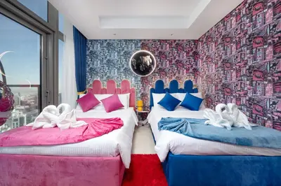 a room with two beds with swans on them at Best Burj Khalifa View Balcony Apartment with 64th-Floor Infinity Pool in Paramount Hotel Midtown in Dubai