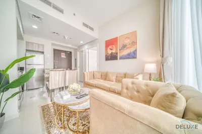 a living room with a couch and a table at Peaceful 1BR at Golf Vita A Damac Hills by Deluxe Holiday Homes in Dubai