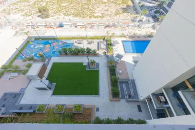 an overhead view of a pool with a lawn at Stylish 2BR Apartment at Dubai Hills with Pool Access By ĀYA Boutique in Dubai