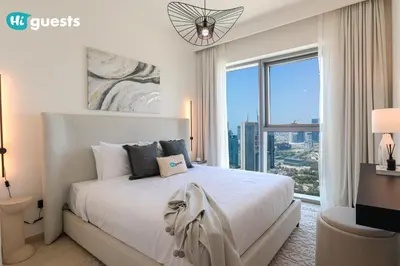 a bedroom with a large bed with a large window at HiGuests - Sky-High Luxury 2BR Apt in Downtown Views Dubai in Dubai