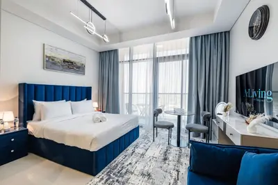 a hotel room with a bed and a desk at A Living - Luxury Studio Apartment in Aykon City Canal Views, Business bay in Dubai