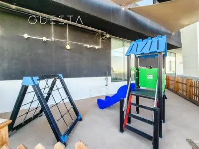 a play room with a climbing frame and a swing set at Bayz Tower, Business Bay in Dubai
