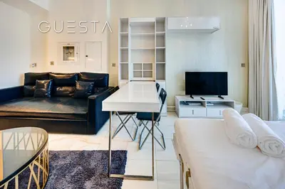 a living room with a couch and a table at Bayz Tower, Business Bay in Dubai