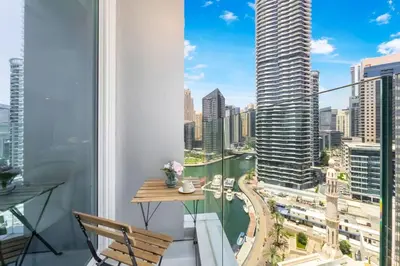 a balcony with a table and a view of a city at FAM Living - Stunning Modern Marina Apartment in Dubai