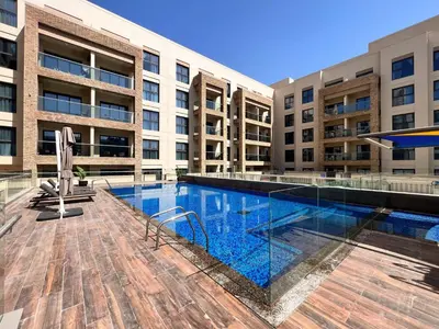 a swimming pool in front of a building at Frank Porter - Eleganz 5 in Dubai