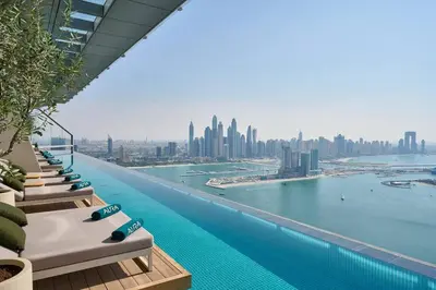 a infinity pool with a view of the city at Palm Tower Luxury 1BR Sea View Suites with 5 Star Hotel Amenities in Dubai