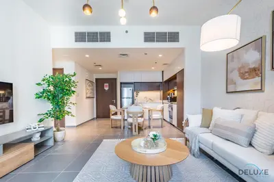 a living room with a couch and a table at Charming 1BR Apartment in Creek Edge Tower 1, Dubai Creek Harbor by Deluxe Holiday Homes in Dubai