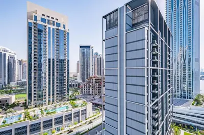 an aerial view of a tall building in a city at Charming 1BR Apartment in Creek Edge Tower 1, Dubai Creek Harbor by Deluxe Holiday Homes in Dubai