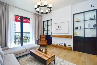 a living room with a couch and a table at Luxury Escapes - Sea View 1Bed Apartment in Port de Lamer in Dubai