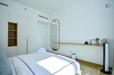 a hospital room with a bed and a mirror at Luxury Escapes - Sea View 1Bed Apartment in Port de Lamer in Dubai