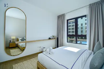a bedroom with a large mirror and a bed at Luxury Escapes - Sea View 1Bed Apartment in Port de Lamer in Dubai