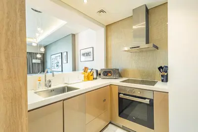 a kitchen with a sink and a stove at Dubai Dreaming Stylish 1BR, DAMAC Towers Paramount in Dubai