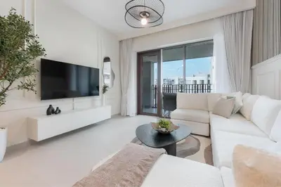 a living room with a white couch and a tv at HAVN - 1 Bedroom in Bayshore 2, Creek Beach in Dubai