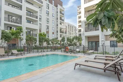 a swimming pool in a apartment with two buildings at HAVN - 1 Bedroom in Bayshore 2, Creek Beach in Dubai
