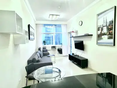 a living room with a couch and a table at JBR Walk Full Apartment Marina View in Dubai