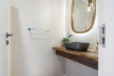 a bathroom with a sink and a mirror at Ocean View 2BR with a Pool & Gym, 2 min to Beach in Dubai
