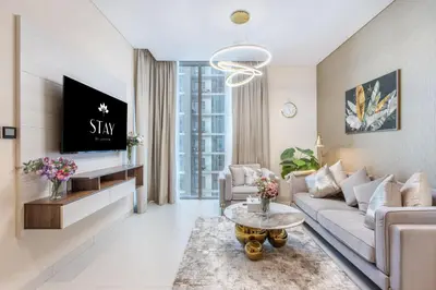a living room with a couch and a table at STAY BY LATINEM Luxury 1BR Holiday Home CVR A2003 near Burj Khalifa in Dubai