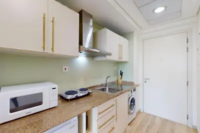 a kitchen with a microwave and a sink at Goldcrest Views 2 - Elegant Studio in Dubai