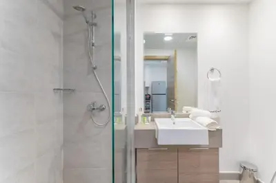 a bathroom with a shower and a sink at HAVN - Studio Apartment in Bloom Towers, JVC in Dubai