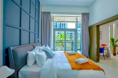 a bedroom with a bed and a large window at New Modern Apartment 1BHK 5 min walk to Dubai Mall 99walk score in Dubai