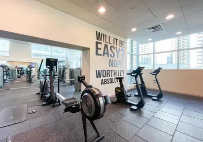 a gym with several treadmills and exercise bikes at New Modern Apartment 1BHK 5 min walk to Dubai Mall 99walk score in Dubai