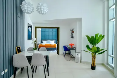 a room with a table and chairs and a bed at New Modern Apartment 1BHK 5 min walk to Dubai Mall 99walk score in Dubai
