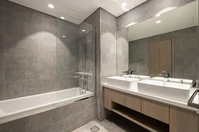 a bathroom with two sinks and a bath tub at Stella Maris - Beachfront Premium 3 Bedroom Apt in Dubai
