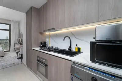 a kitchen with a sink and a microwave at Nasma Luxury Stays - Laya Heights in Dubai