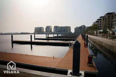 a dock with a marina next to the water with buildings at Veluxa - Stunning Sea View - Luxe 3 Bed in La Mer in Dubai