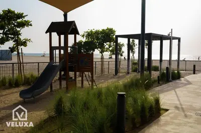 a playground with a slide next to the beach at Veluxa - Stunning Sea View - Luxe 3 Bed in La Mer in Dubai