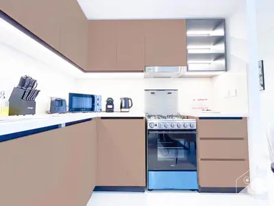 a kitchen with white cabinets and a stove at Luxury & Elegance at Burj Crown Downtown in Dubai