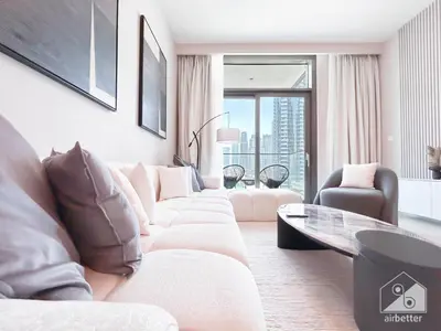 a living room with a white couch and a glass table at Luxury & Elegance at Burj Crown Downtown in Dubai