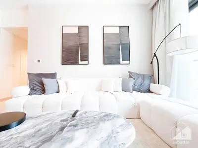 a white living room with a white couch at Luxury & Elegance at Burj Crown Downtown in Dubai