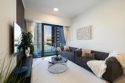 a living room with a couch and a table at Luxe 2-Bedroom In Heart Of Dubai Marina in Dubai