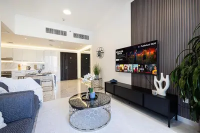 a living room with a couch and a tv at Luxe 2-Bedroom In Heart Of Dubai Marina in Dubai