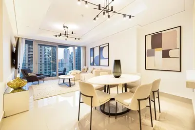 a living room with a table and chairs at Stunning Burj & Fountain Views Luxury 2 BR in Dubai