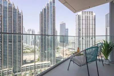 a balcony with a chair and a view of a city at Frank Porter - Opera Grand in Dubai