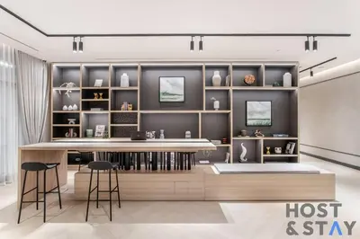 a room with a counter with stools and shelves at Boutique Studio in Wilton Park MBR City in Dubai