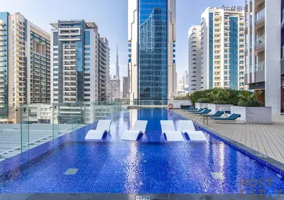 a swimming pool in a city with tall buildings at Upgraded Studio in Business Bay in Dubai