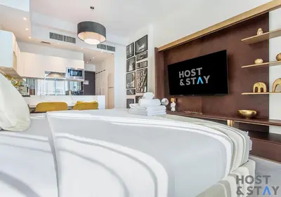 a white bed in a room with a bedzinski at Upgraded Studio in Business Bay in Dubai