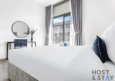 a bedroom with a large bed and a mirror at Comfy 1BR at JVC - Ideal for Family & friends in Dubai