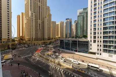 a busy city street with traffic in a city with tall buildings at Elegant studio in Sparkle Tower by Suiteable in Dubai