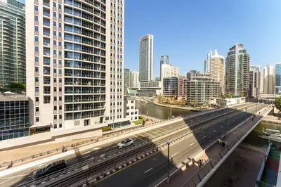 a view of a city with buildings and a highway at Elegant studio in Sparkle Tower by Suiteable in Dubai