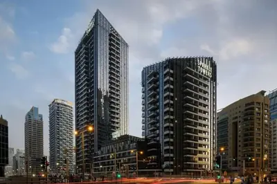two tall buildings in a city with a street at Your gateway in Sparkle Tower JBR by Suiteable in Dubai