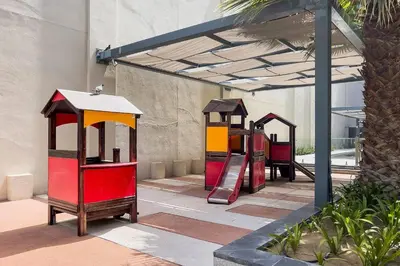 a playground with two play equipment in a building at DAMAC APARTMENTS in Dubai