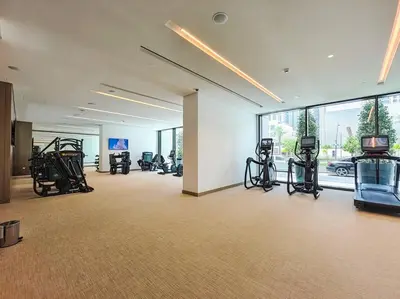 a gym with treadmills and exercise equipment in a building at The Harbor Heights 1BR in Palace Residences Creek in Dubai